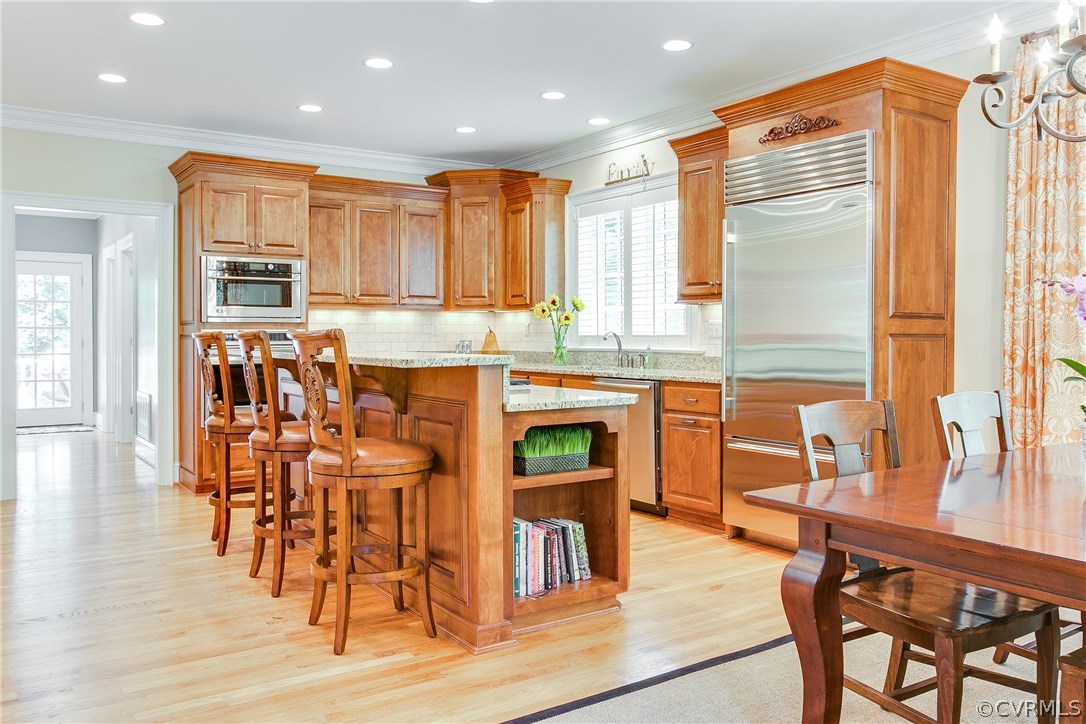 3660 Lansdowne Road Midlothian, VA 23113 - Photo 15 of 50 a kitchen with stainless steel appliances granite countertop wooden floor a dining table and chairs
