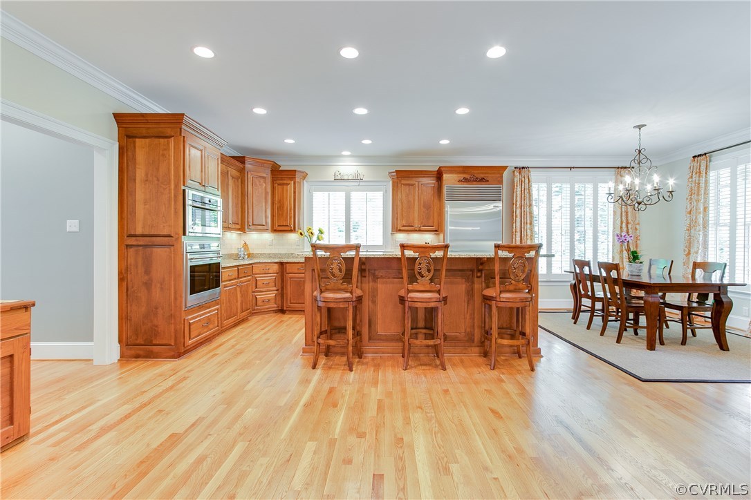 3660 Lansdowne Road Midlothian, VA 23113 - Photo 16 of 50 an open kitchen with dining table wooden floor and a large window