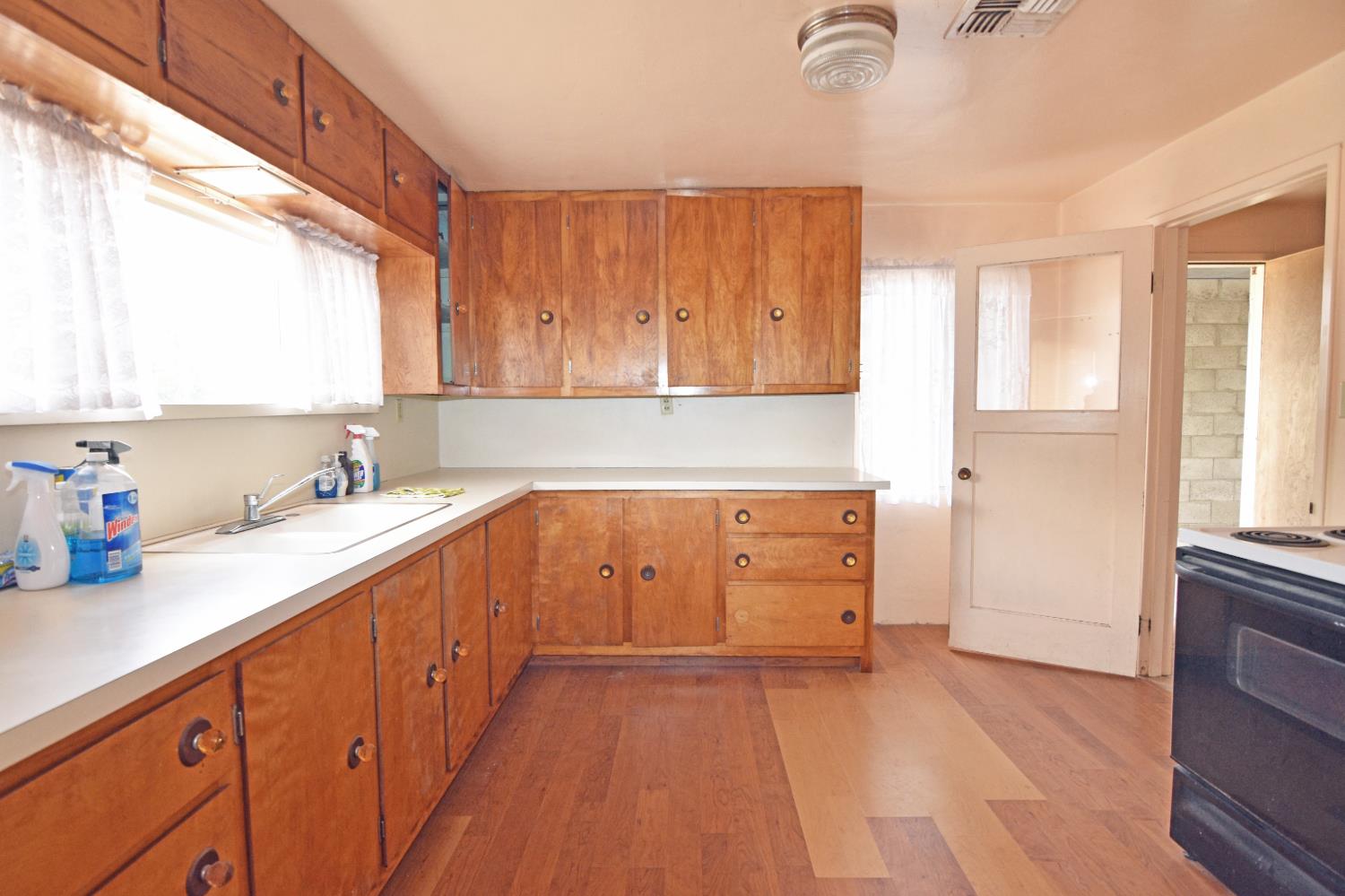 1206 South Verduga Road Turlock, CA 95380 - Photo 10 of 36 a kitchen with sink cabinets and window