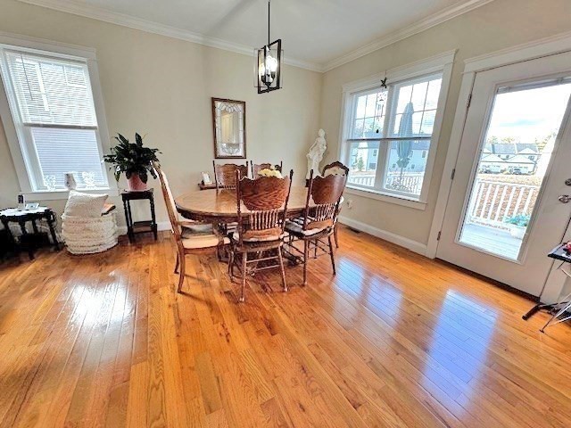6 Nautical Way, Unit 122 Douglas, MA 01516 - Photo 13 of 42 a dining room with wooden floor a chandelier a glass table and chairs