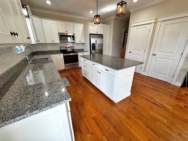 6 Nautical Way, Unit 122 Douglas, MA 01516 - Photo 15 of 42 a kitchen with stainless steel appliances granite countertop a refrigerator a sink dishwasher a stove and white countertops with wooden floor