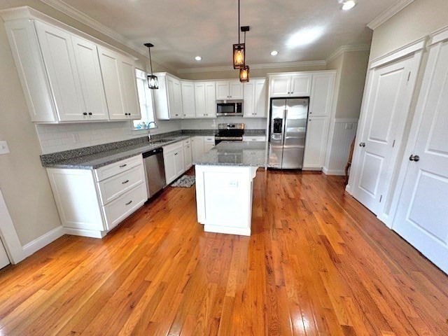 6 Nautical Way, Unit 122 Douglas, MA 01516 - Photo 16 of 42 an open kitchen with wooden floor and stainless steel appliances