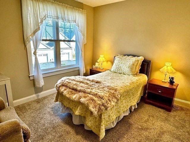 6 Nautical Way, Unit 122 Douglas, MA 01516 - Photo 27 of 42 a bed sitting in a bedroom next to a window