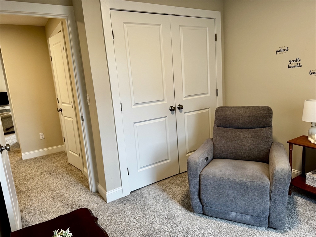 6 Nautical Way, Unit 122 Douglas, MA 01516 - Photo 30 of 42 a living room with furniture and a gate