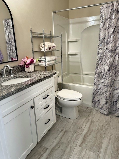 6 Nautical Way, Unit 122 Douglas, MA 01516 - Photo 31 of 42 a bathroom with a granite countertop sink a toilet and a mirror