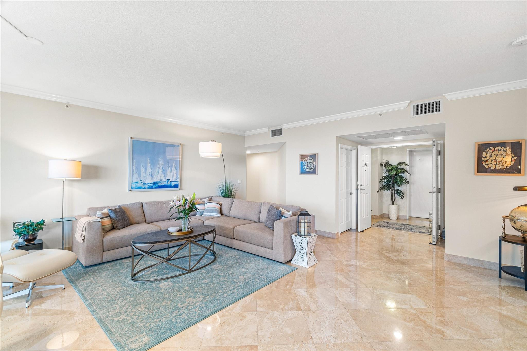 100 South Birch Road, Unit 904 Fort Lauderdale, FL 33316 - Photo 10 of 51 a living room with furniture and a potted plant on table