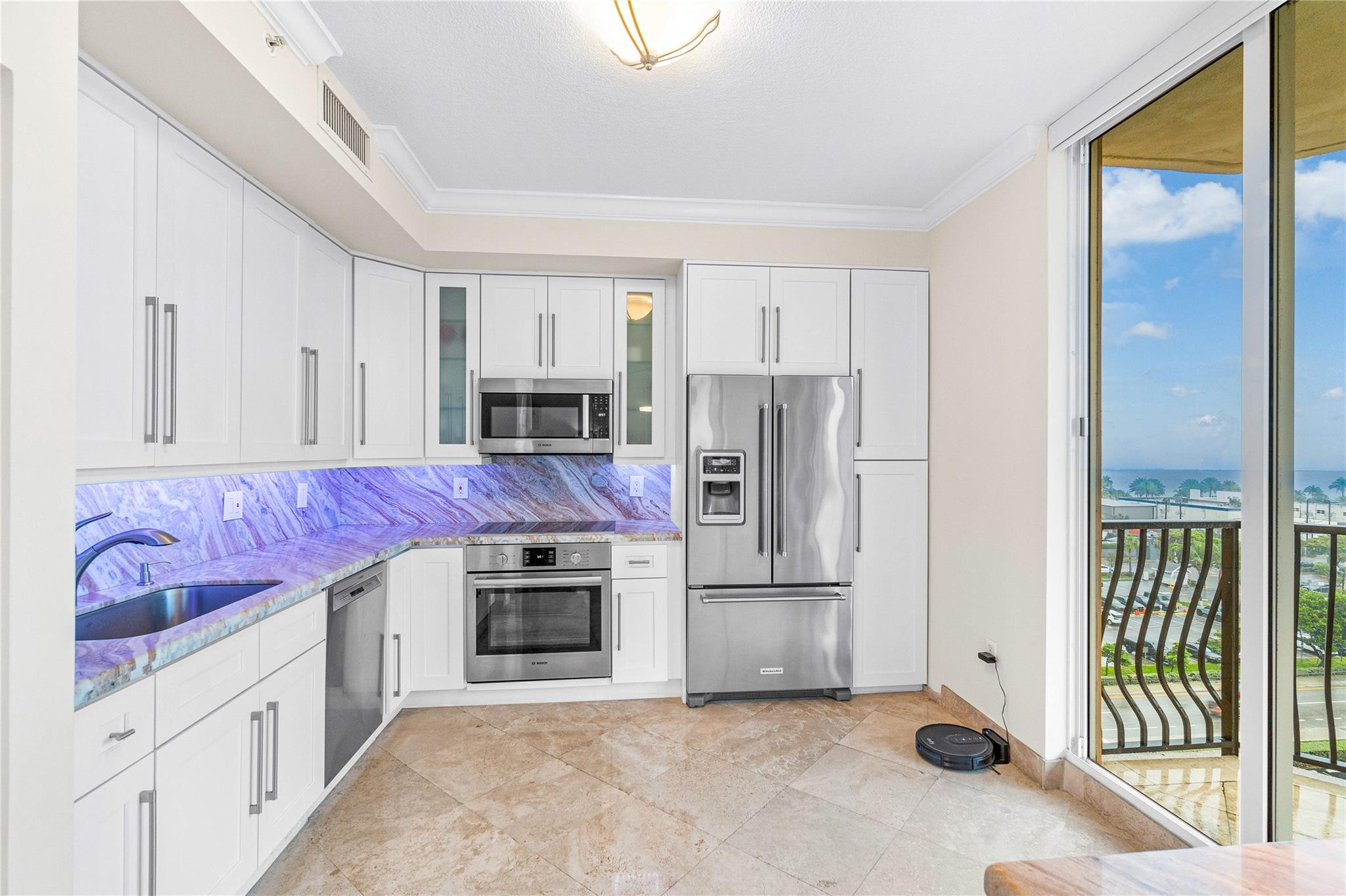 100 South Birch Road, Unit 904 Fort Lauderdale, FL 33316 - Photo 14 of 51 a kitchen with granite countertop a refrigerator and a stove