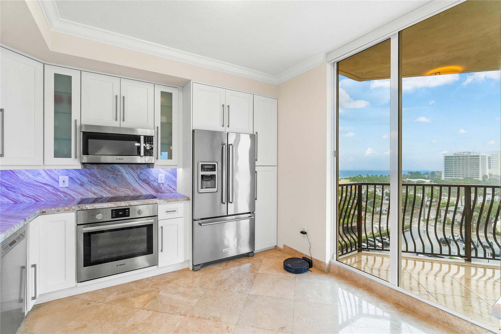 100 South Birch Road, Unit 904 Fort Lauderdale, FL 33316 - Photo 15 of 51 a kitchen with granite countertop a refrigerator and a stove