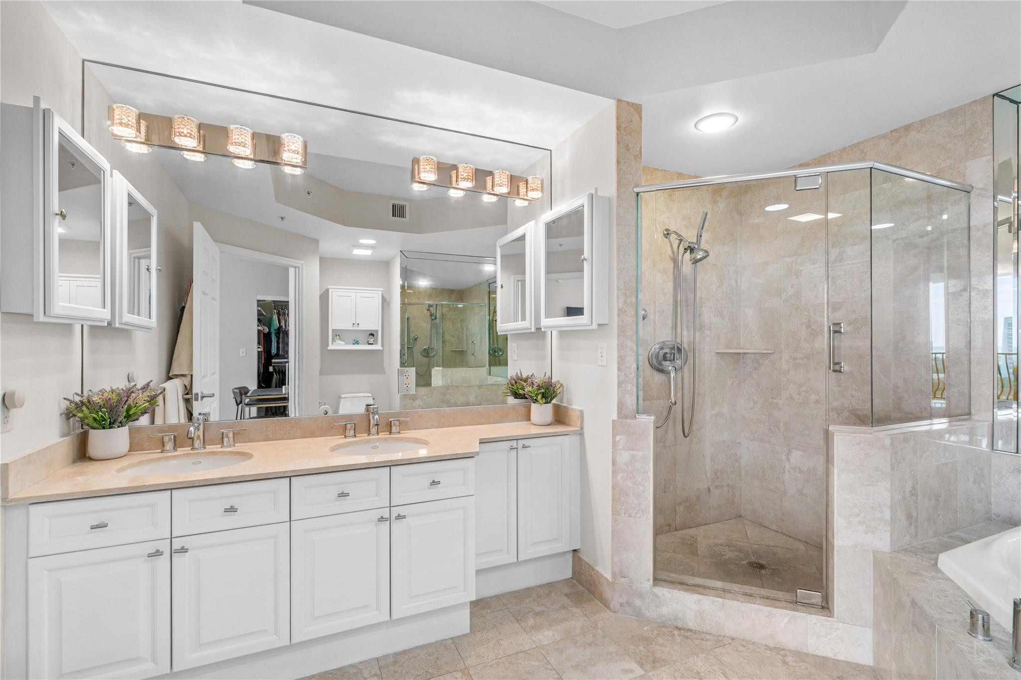 100 South Birch Road, Unit 904 Fort Lauderdale, FL 33316 - Photo 21 of 51 a spacious bathroom with a shower sink and mirror