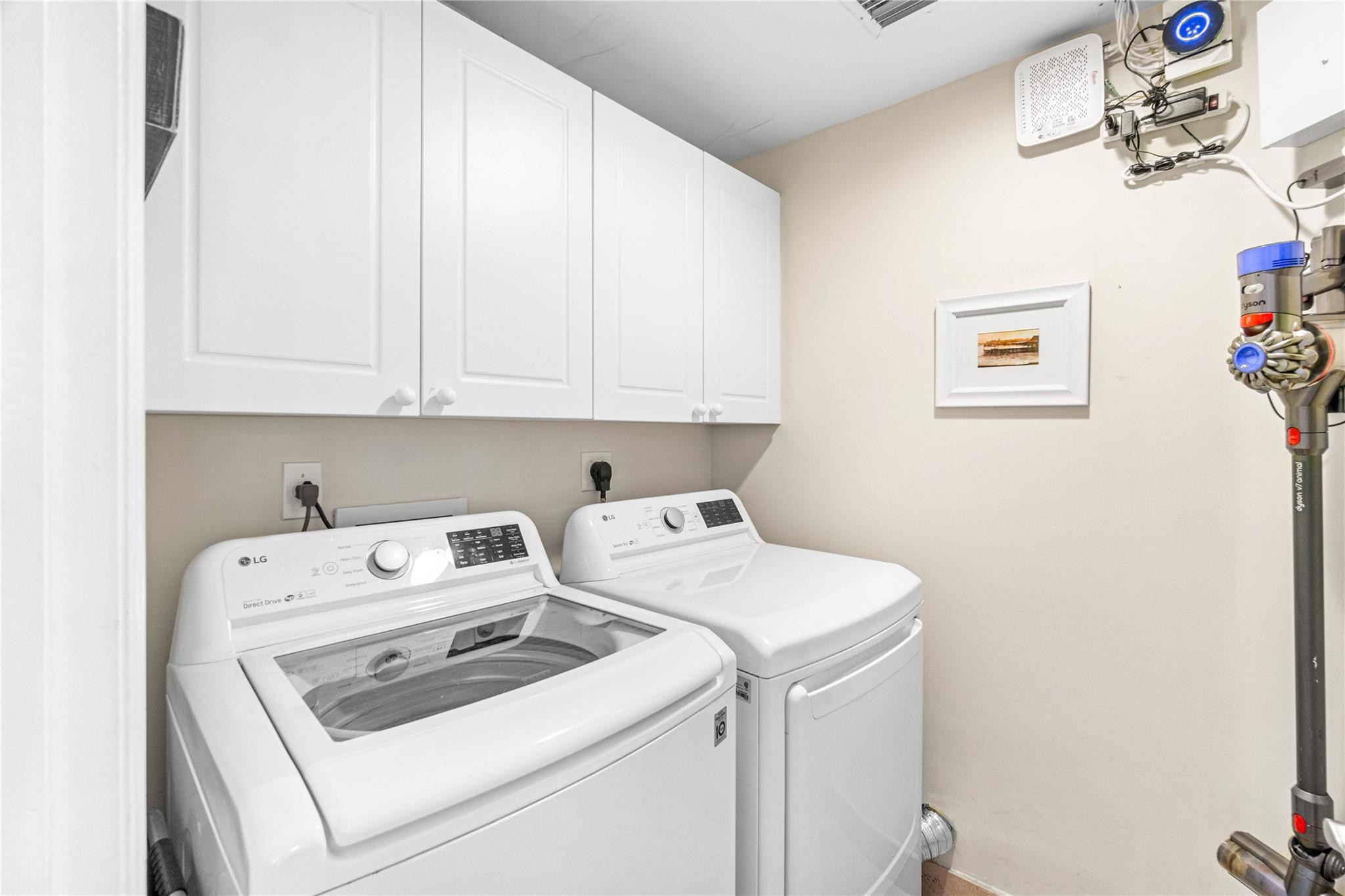 100 South Birch Road, Unit 904 Fort Lauderdale, FL 33316 - Photo 50 of 51 a view of washer and dryer with kitchen in the background