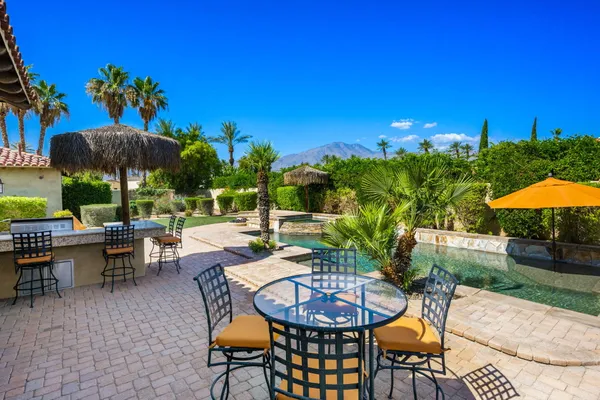 a spacious bedroom with a bed and a flat screen tv