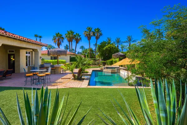 a spacious bathroom with a tub sink and mirror