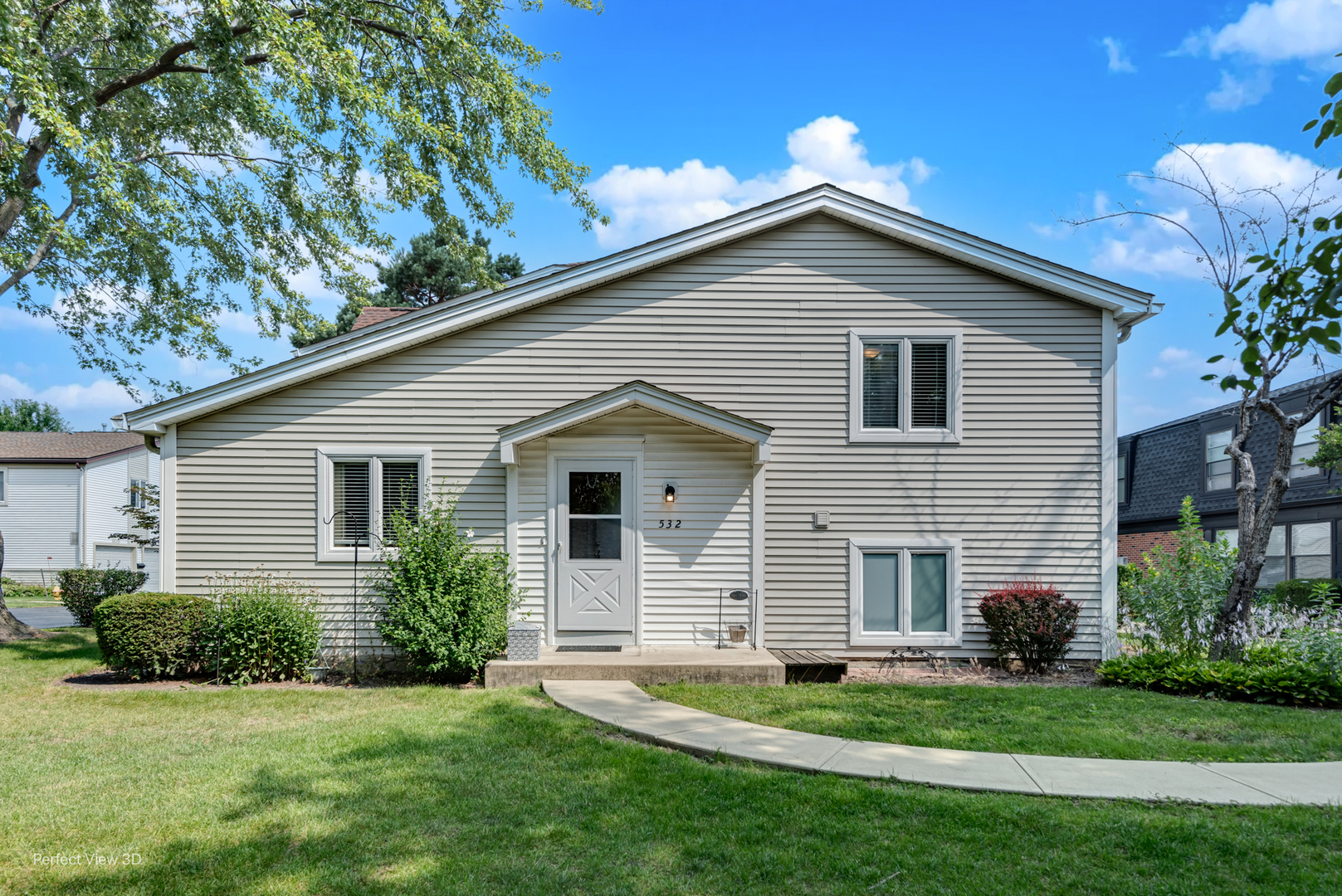 a front view of a house with a garden