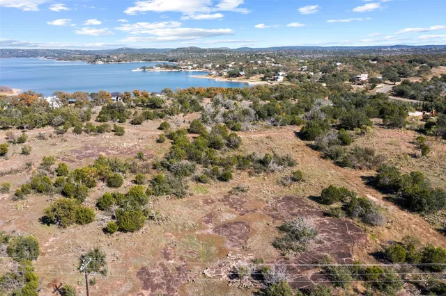 an aerial view of a house with a lake view