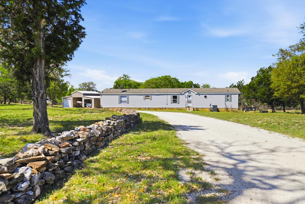 912 Alamo Road Fredericksburg, TX 78624 - Photo 1 of 21 a view of lake with a house in the background