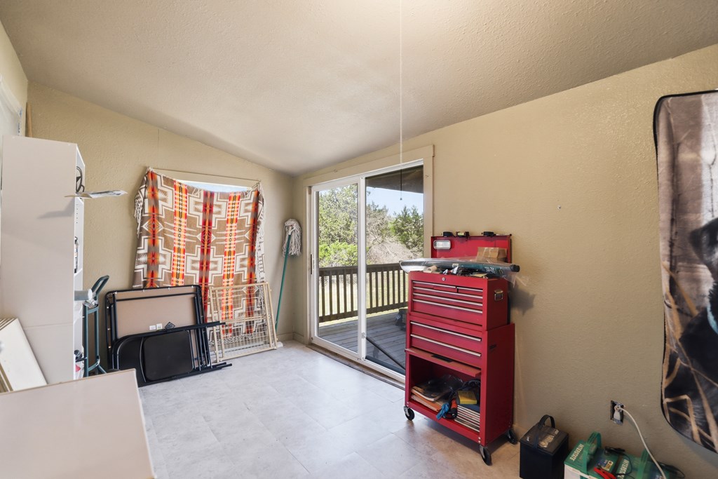 912 Alamo Road Fredericksburg, TX 78624 - Photo 14 of 21 a bedroom with furniture and a window