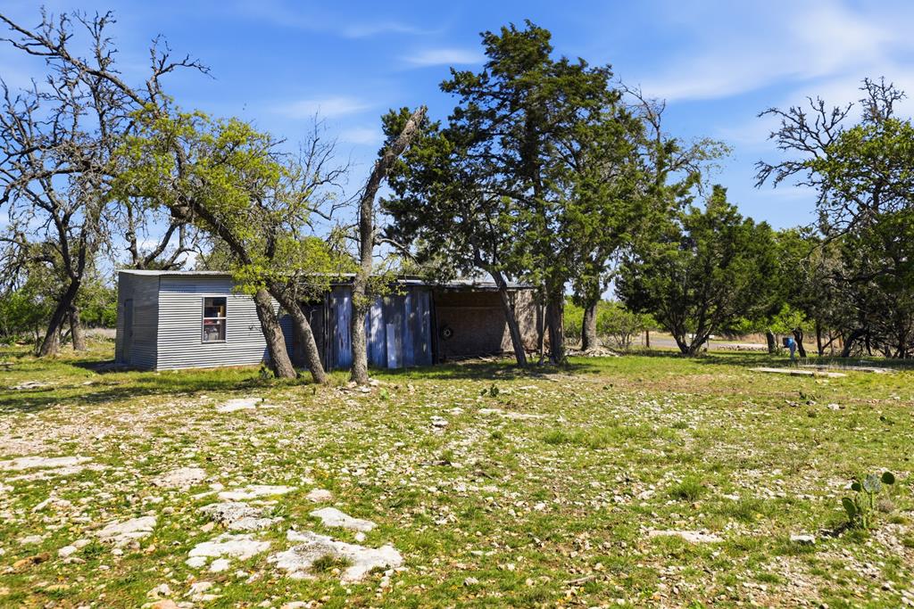 912 Alamo Road Fredericksburg, TX 78624 - Photo 17 of 21 a house with trees in the background