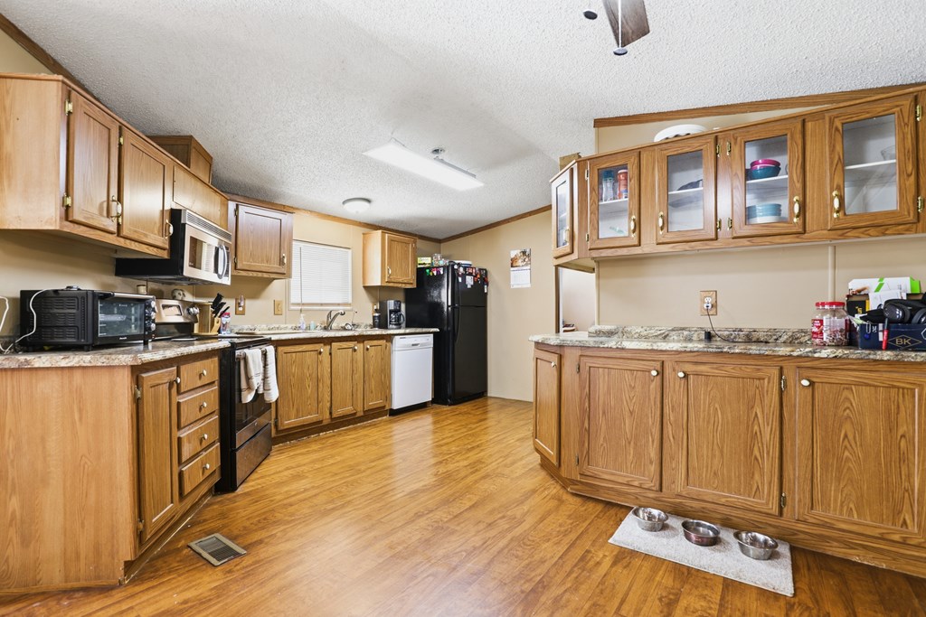 912 Alamo Road Fredericksburg, TX 78624 - Photo 3 of 21 a kitchen with granite countertop stainless steel appliances and cabinets
