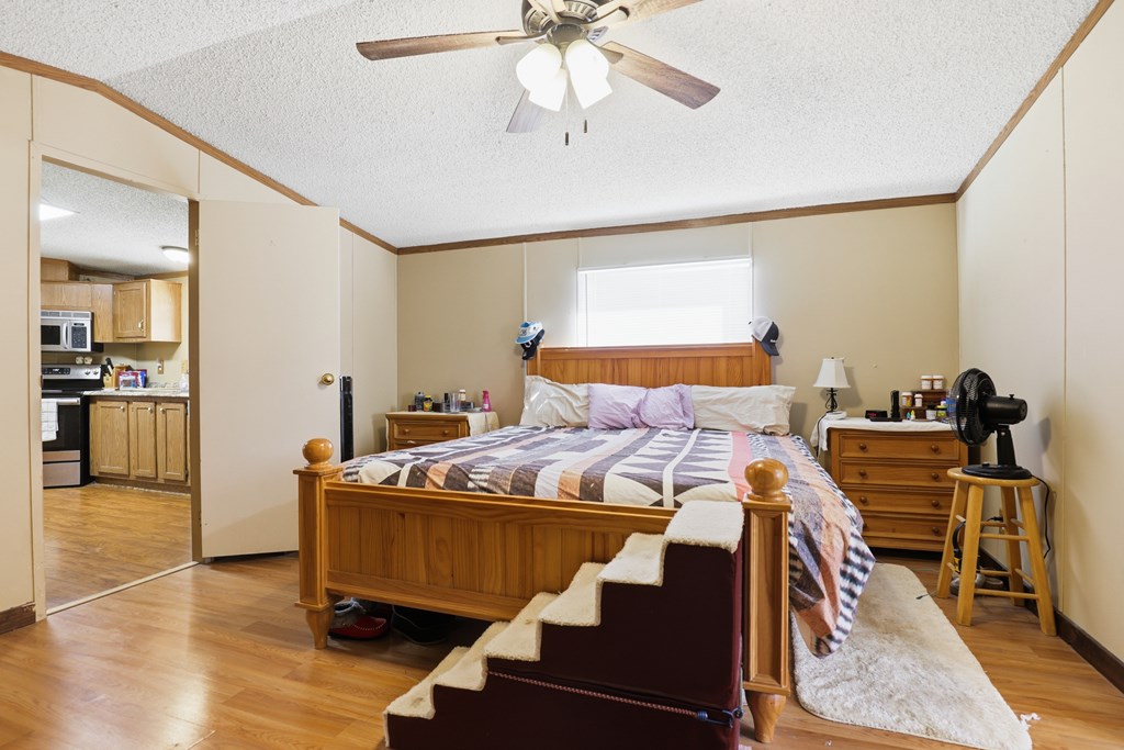 912 Alamo Road Fredericksburg, TX 78624 - Photo 7 of 21 a bedroom with furniture and a wooden floor