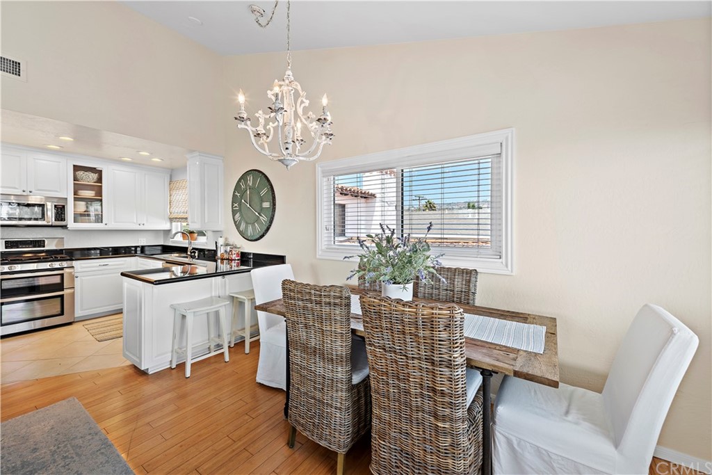 312 Avenida Granada, Unit A San Clemente, CA 92672 - Photo 11 of 25 a very nice looking dining room with kitchen island stainless steel appliances a table and chairs