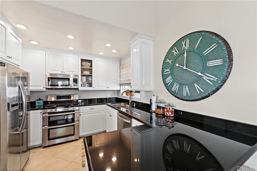 312 Avenida Granada, Unit A San Clemente, CA 92672 - Photo 12 of 25 a kitchen with stainless steel appliances granite countertop a sink a stove and a microwave