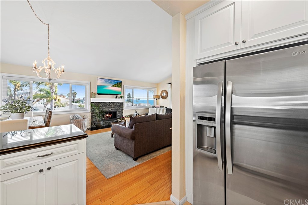 312 Avenida Granada, Unit A San Clemente, CA 92672 - Photo 14 of 25 a living room with fireplace furniture and a chandelier