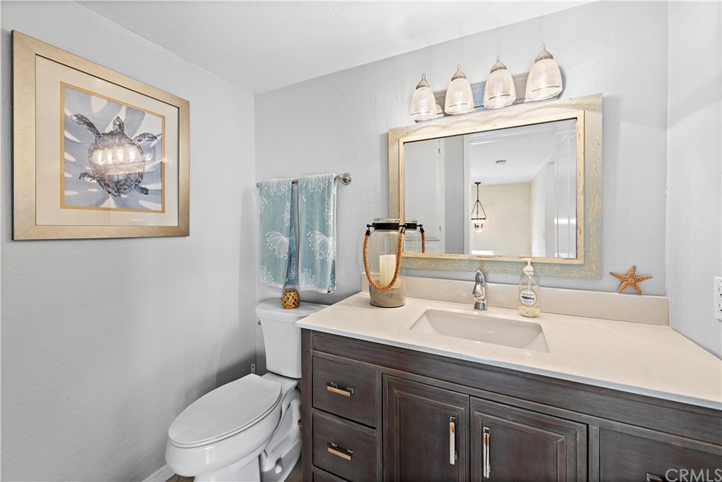 312 Avenida Granada, Unit A San Clemente, CA 92672 - Photo 16 of 25 a bathroom with a toilet a sink and a mirror