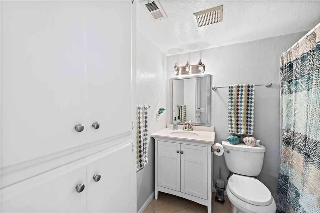 312 Avenida Granada, Unit A San Clemente, CA 92672 - Photo 19 of 25 a bathroom with a toilet sink and mirror