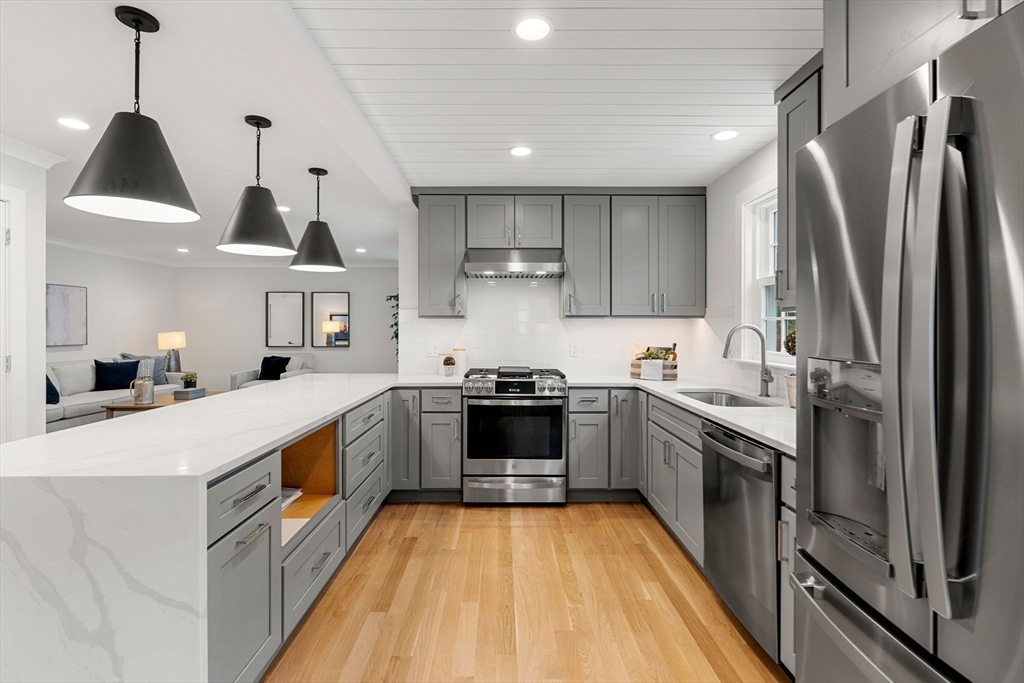 143 Derby Street, Unit 1 Salem, MA 01970 - Photo 11 of 42 a kitchen with stainless steel appliances granite countertop a stove a sink and a refrigerator