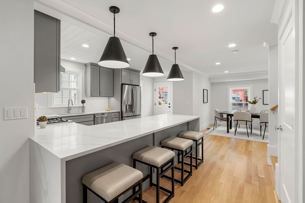 143 Derby Street, Unit 1 Salem, MA 01970 - Photo 12 of 42 a dining room with furniture and wooden floor