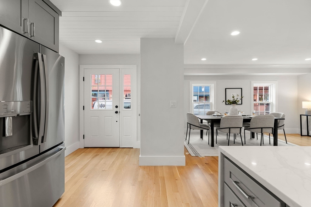 143 Derby Street, Unit 1 Salem, MA 01970 - Photo 16 of 42 a kitchen with stainless steel appliances granite countertop a refrigerator and a stove top oven