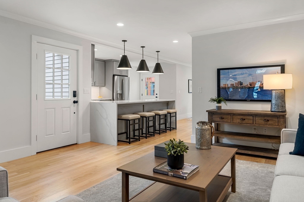 143 Derby Street, Unit 1 Salem, MA 01970 - Photo 21 of 42 a living room with furniture a rug and a kitchen