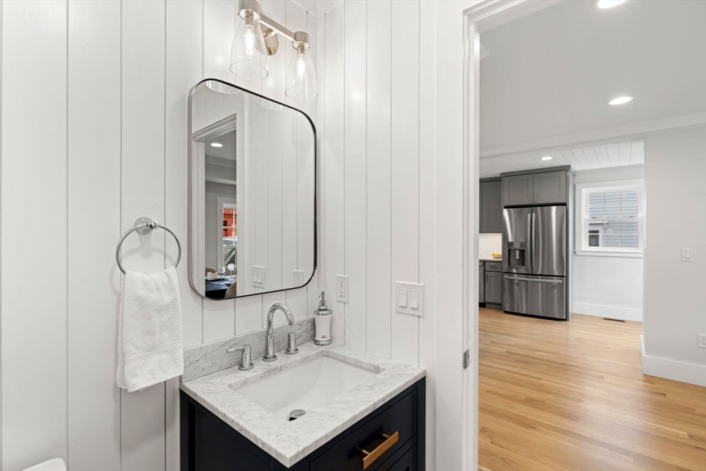 143 Derby Street, Unit 1 Salem, MA 01970 - Photo 23 of 42 a bathroom with a sink a shower a mirror and cabinets
