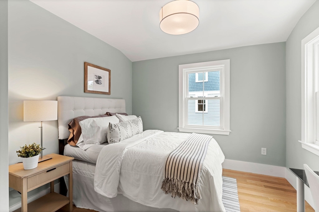 143 Derby Street, Unit 1 Salem, MA 01970 - Photo 24 of 42 a bedroom with a bed and a lamp