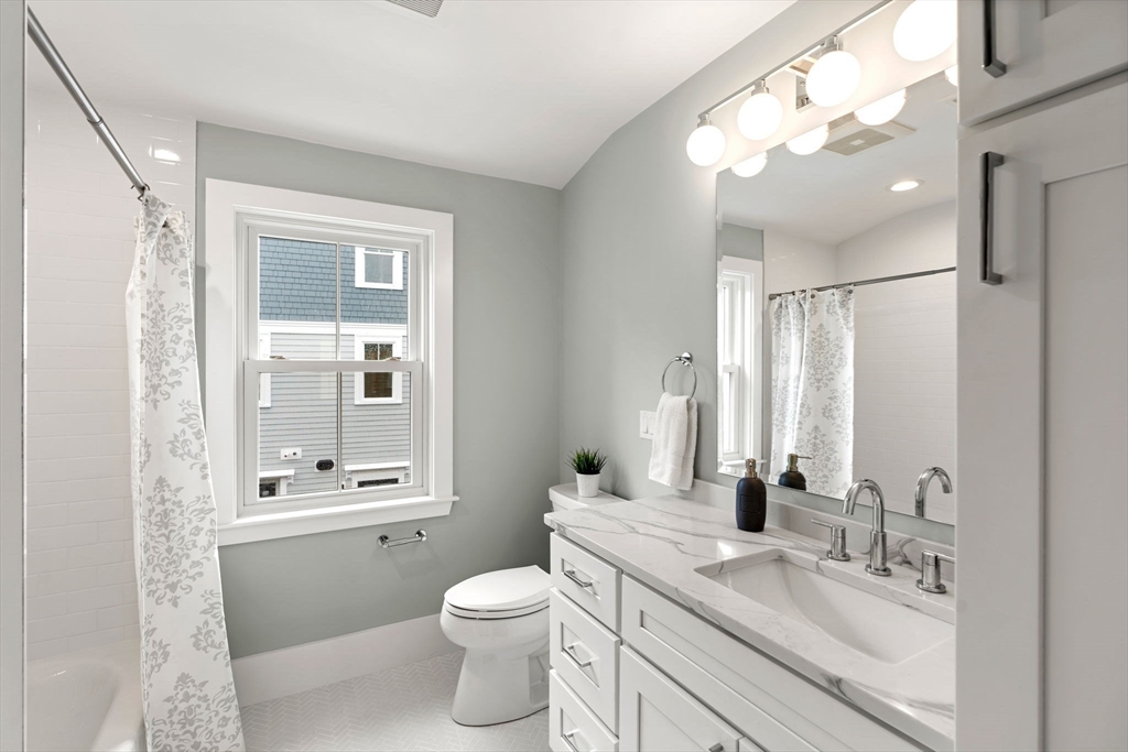 143 Derby Street, Unit 1 Salem, MA 01970 - Photo 28 of 42 a bathroom with a granite countertop sink toilet and shower