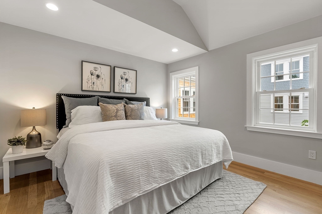 143 Derby Street, Unit 1 Salem, MA 01970 - Photo 29 of 42 a bedroom with a bed and wooden floor