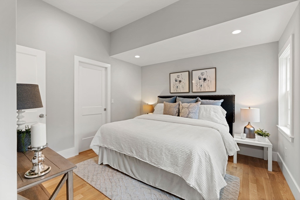 143 Derby Street, Unit 1 Salem, MA 01970 - Photo 30 of 42 a bedroom with a bed and wooden floor