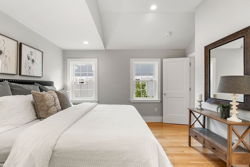 143 Derby Street, Unit 1 Salem, MA 01970 - Photo 32 of 42 a bedroom with a large bed and a window
