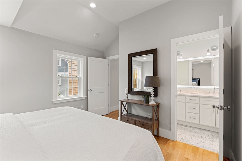 143 Derby Street, Unit 1 Salem, MA 01970 - Photo 33 of 42 a bedroom with a bed and a view of kitchen