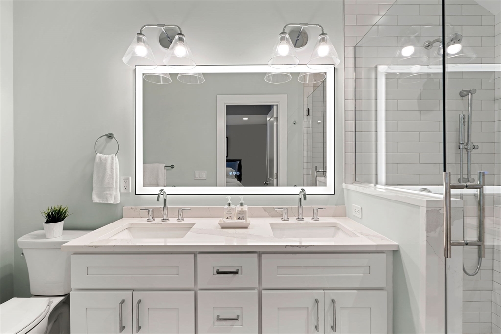 143 Derby Street, Unit 1 Salem, MA 01970 - Photo 34 of 42 a bathroom with a sink vanity and a mirror