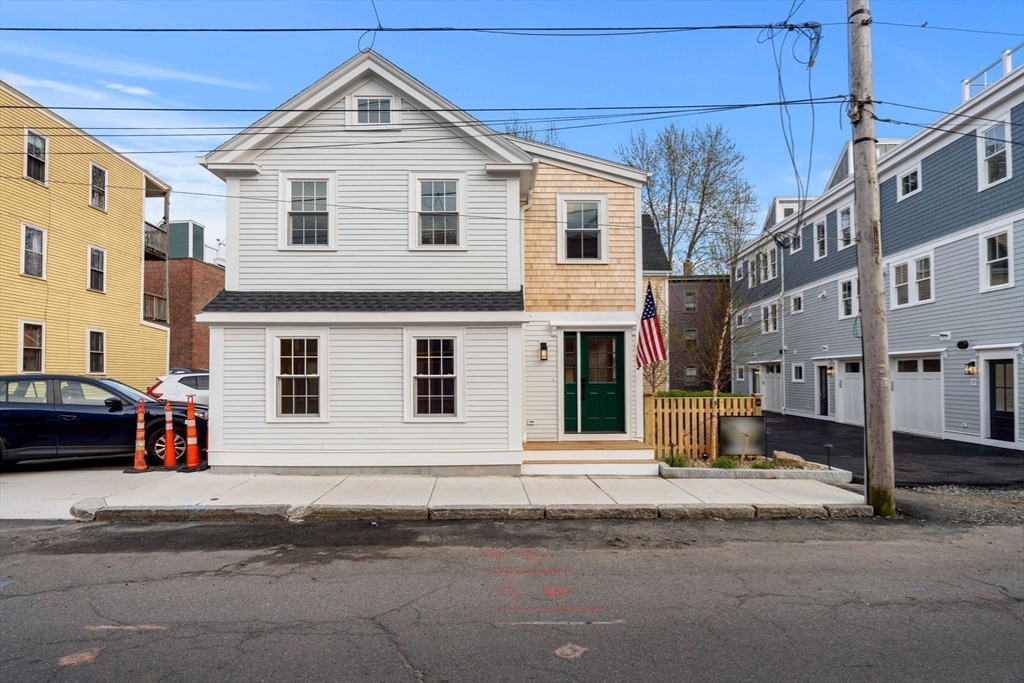 143 Derby Street, Unit 1 Salem, MA 01970 - Photo 36 of 42 a view of a white house with a large windows