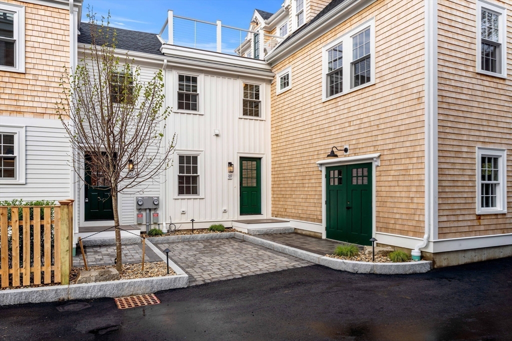 143 Derby Street, Unit 1 Salem, MA 01970 - Photo 37 of 42 a view of a house with a small garden