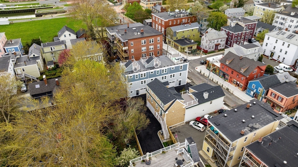 143 Derby Street, Unit 1 Salem, MA 01970 - Photo 40 of 42 an aerial view of a house with swimming pool large trees and buildings