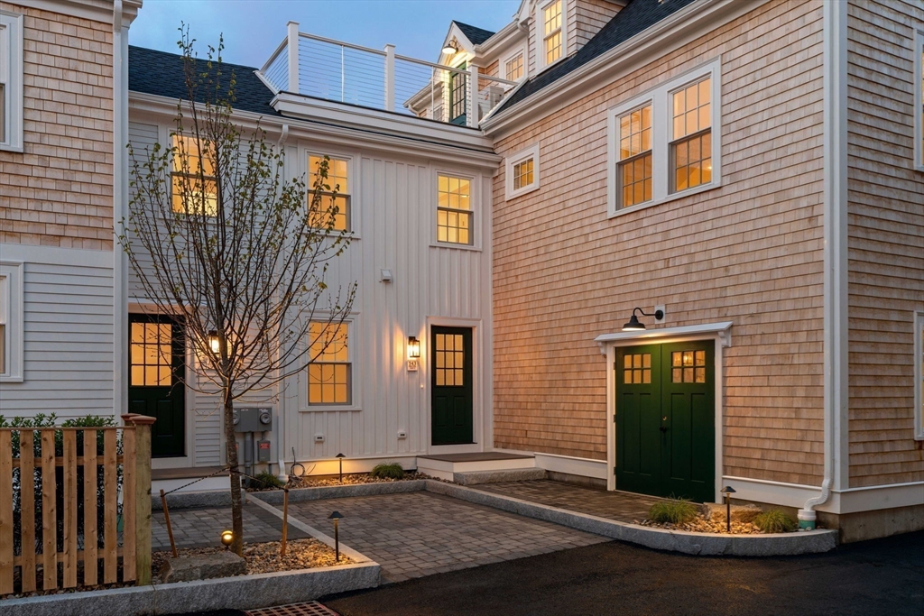 143 Derby Street, Unit 1 Salem, MA 01970 - Photo 4 of 42 a view of a brick house with many windows