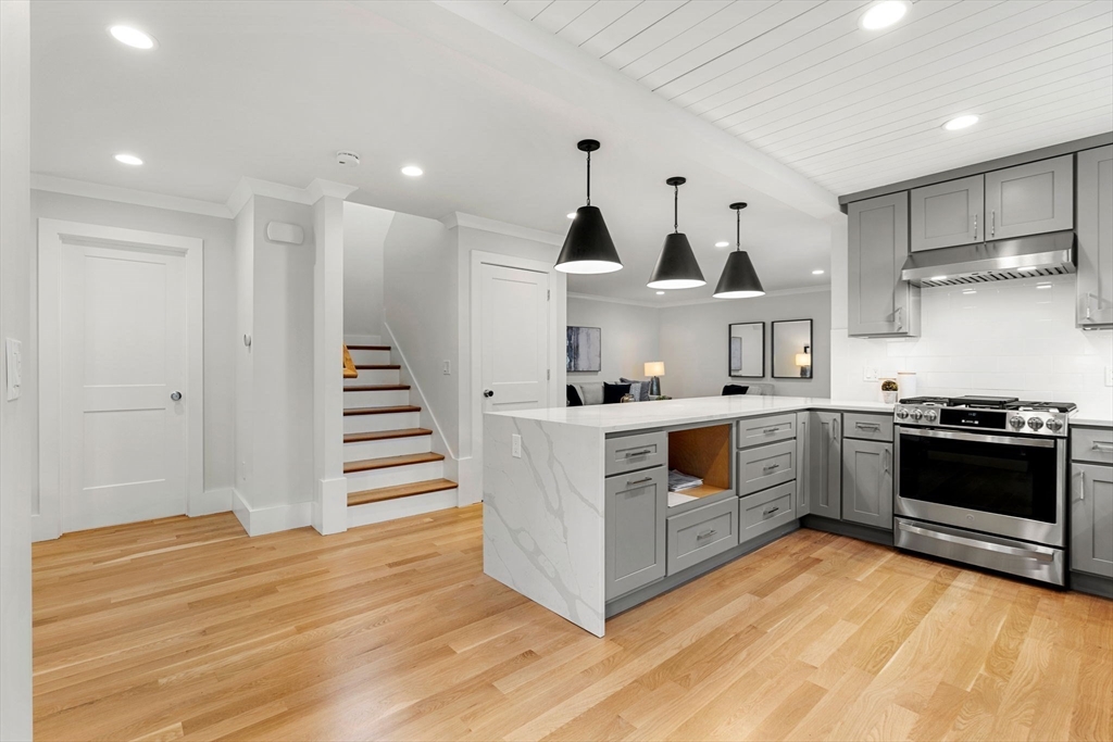 143 Derby Street, Unit 1 Salem, MA 01970 - Photo 9 of 42 a kitchen with stainless steel appliances a stove top oven and cabinets