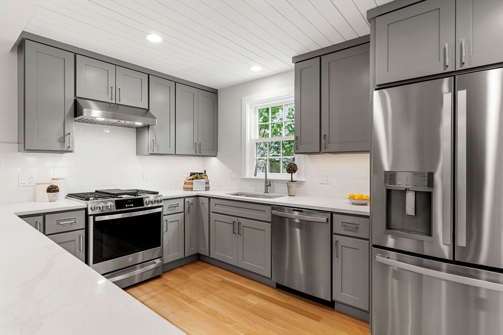 143 Derby Street, Unit 1 Salem, MA 01970 - Photo 10 of 42 a kitchen with stainless steel appliances granite countertop a sink stove and refrigerator