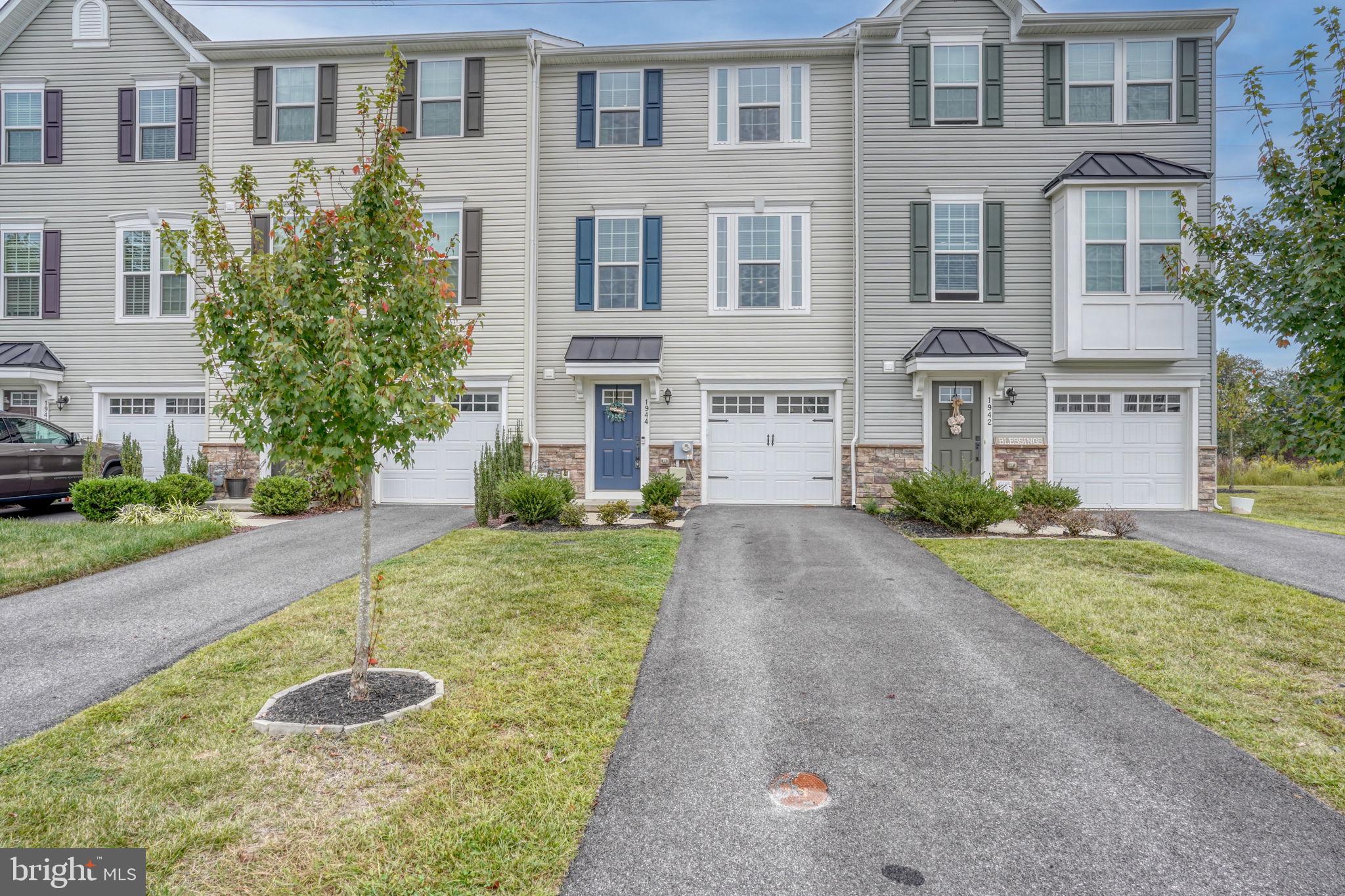 1944 Spearfish Court Newark, DE 19702 - Photo 1 of 44 a front view of a house with a yard and garage