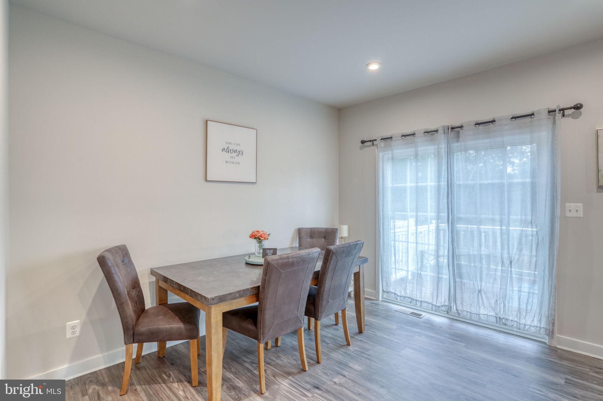 1944 Spearfish Court Newark, DE 19702 - Photo 21 of 44 a view of a dining room with furniture and wooden floor