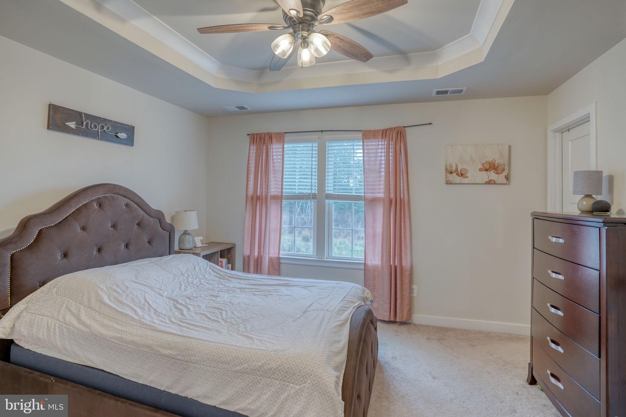 1944 Spearfish Court Newark, DE 19702 - Photo 32 of 44 a bedroom with a bed and a chandelier