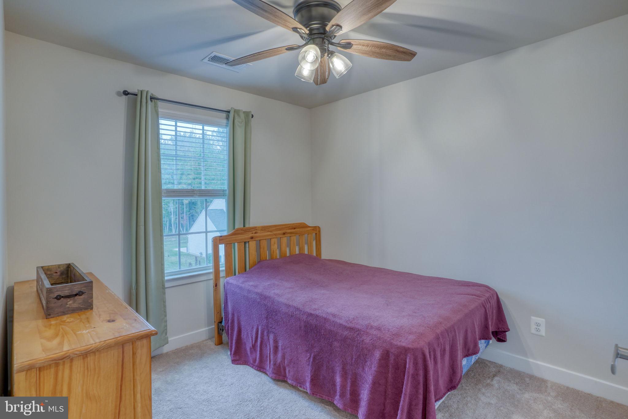1944 Spearfish Court Newark, DE 19702 - Photo 38 of 44 a bedroom with a bed and chandelier